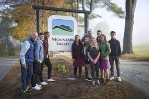 Mountain Valley Treatment Center staff standing by a Mountain Vally sign