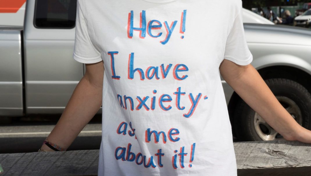 Student wearing a shirt that says Hey I have anxiety, ask me about it