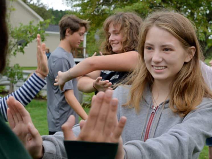 Students touching hands during a team bonding exercise