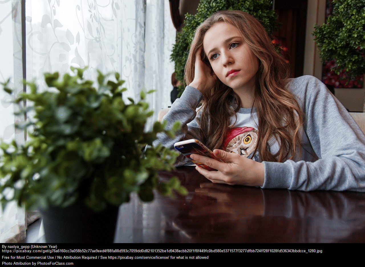 Anxious teen with phone in hand